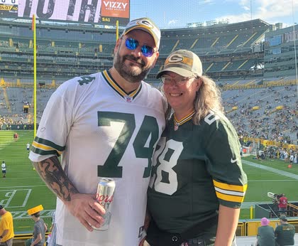 Scott and Robin in Packers gear in the stands at Lambeau Field